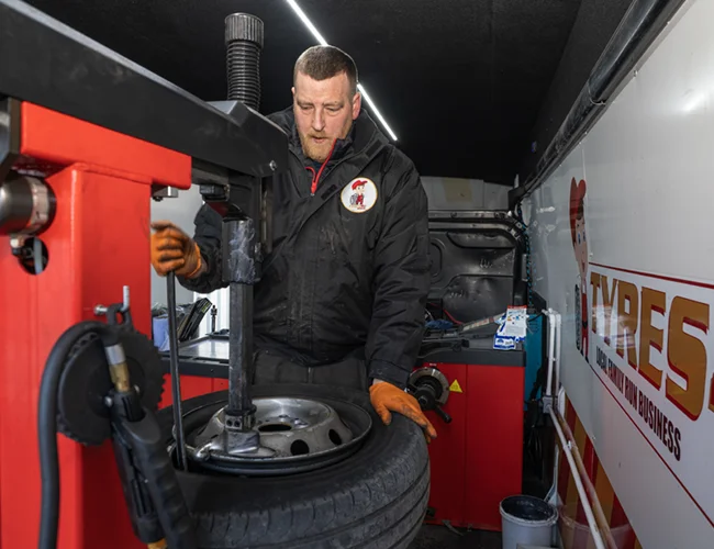 Matt working on tyre in van